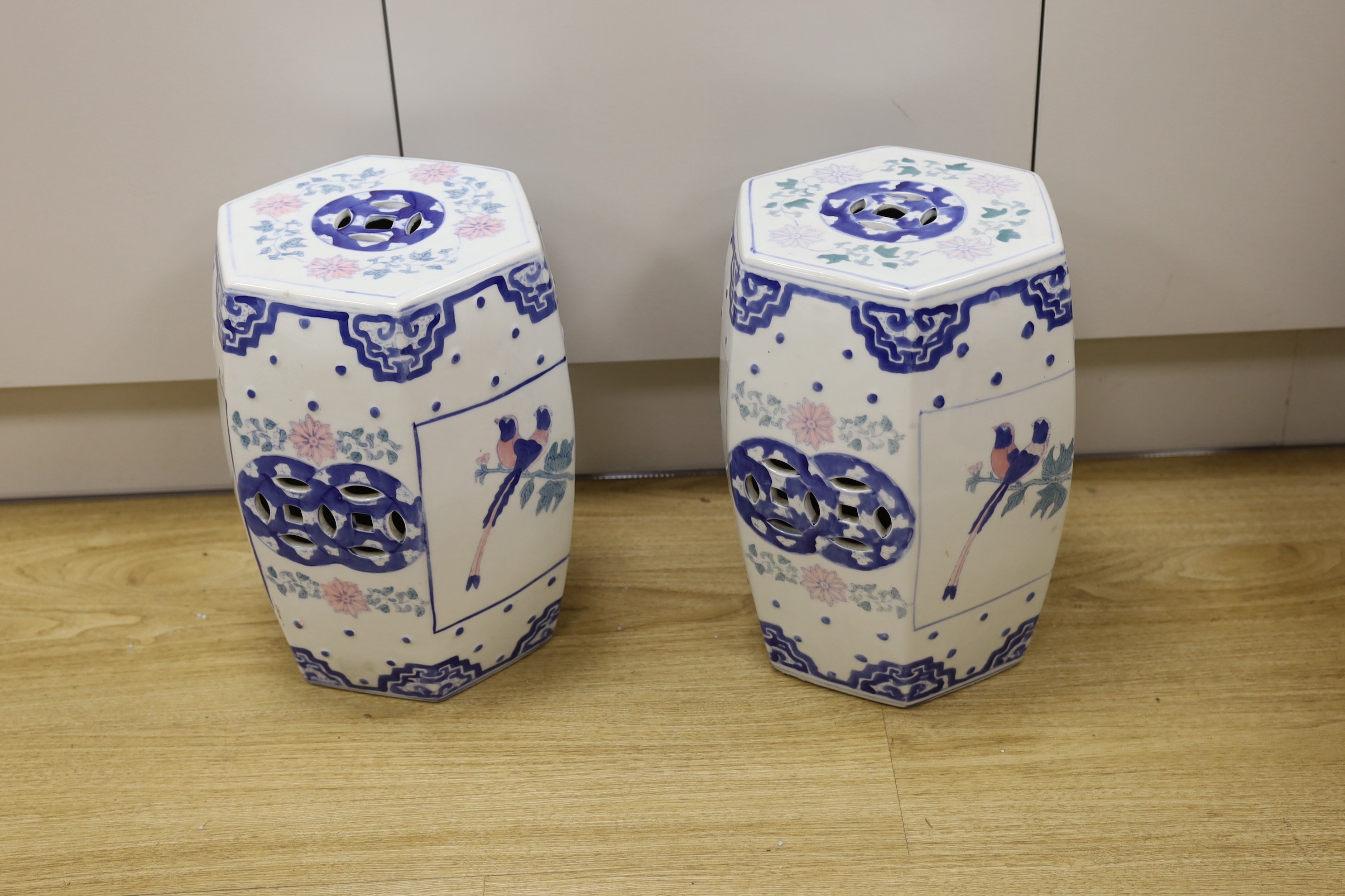 A pair of Chinese porcelain decorative garden seats, 37cms high
